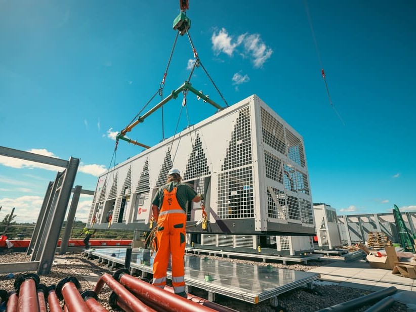 Heat pump lifted into position on roof top